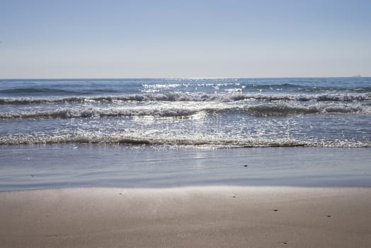 View from seashore of waves on surface of the sea