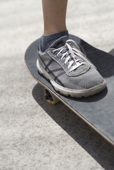 Close up of young skateboarder shoe riding on skateboard