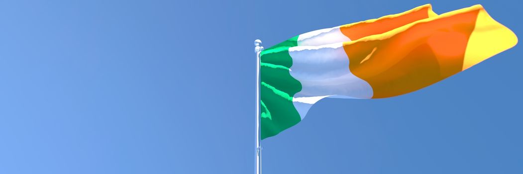 3D rendering of the national flag of Ireland waving in the wind against a blue sky