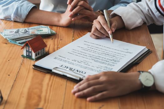 Real estate agents agree to buy a home and give keys to clients at their agency's offices. Concept agreement.