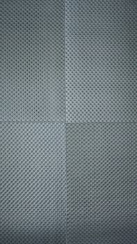 Sound proof padding acoustic soft foam grey color double thick panels layers on the recording studio wall for reduce or absorb or protect this room from other falsetto outside for professional works.