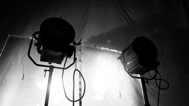 Black and white images of big studio continue LED light for video or film movie production on professional strong steel tripod and promt for shooting or set framing for director