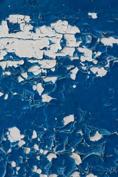 peeling blue paint close up on wood showing texture and pattern
