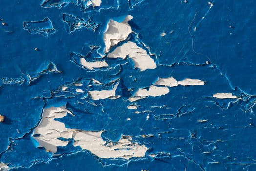 peeling blue paint close up on wood showing texture and pattern