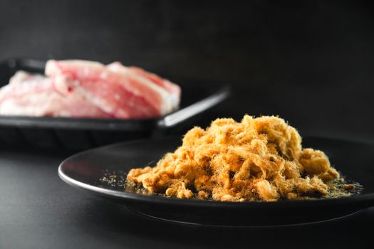 Dried shredded pork on black background, Flossy pork, Raw material