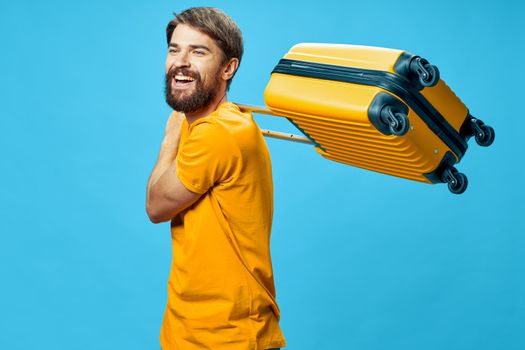 man with yellow suitcase passenger airport international passport luggage blue background