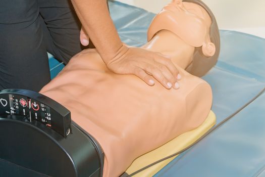 CPR aid dummy medical training with hand press Heart on doll emergency refresher training Concept closed-up.