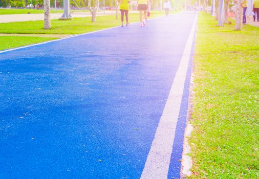 running track in runner rubber cover blue public park. for jogging exercise health, select focus with shallow depth of field