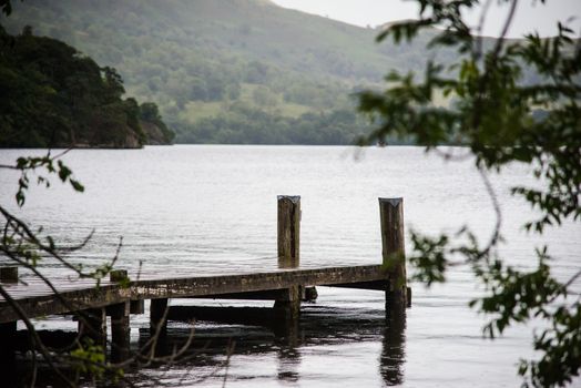 view of stormy skies and jetty north east across ullswater from glenridding