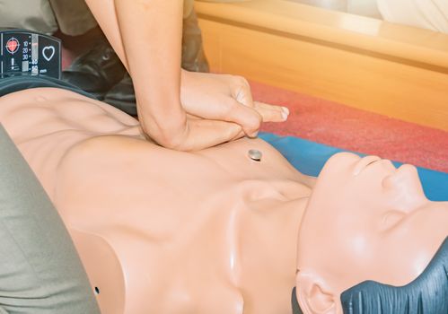 CPR aid dummy medical training with hand press Heart on doll emergency refresher training Concept closed-up.