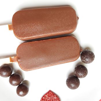 Delicious two chocolate icecream bar with chocolate ball in white plate plated beautifully