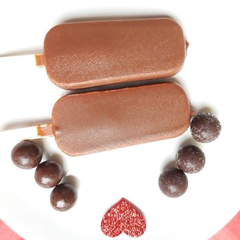 Delicious two chocolate icecream bar with chocolate ball in white plate plated beautifully