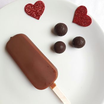 Delicious one chocolate icecream bar with chocolate ball in white plate plated beautifully