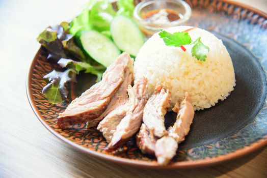 Roast pork with spicy souce rice on table