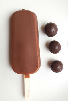 Delicious one chocolate icecream bar with chocolate ball in white plate plated beautifully