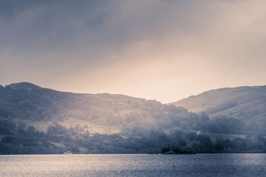 view of stormy skies north east across ullswater from glenridding