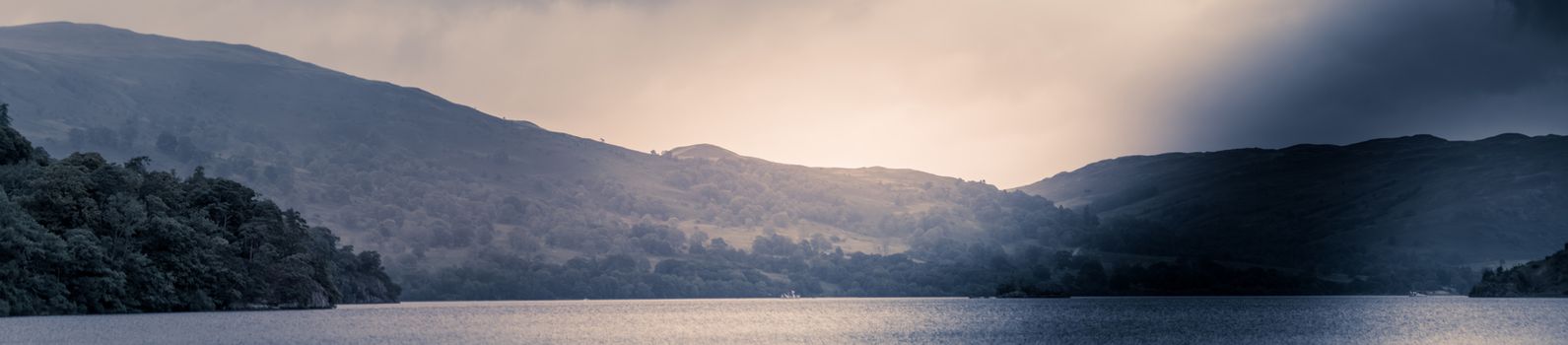 view of stormy skies north east across ullswater from glenridding