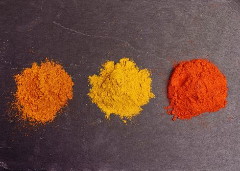 Colorful spices on black background