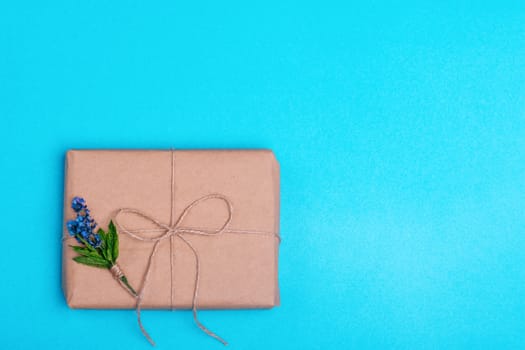 Gift box and a posy of lavender on blue background