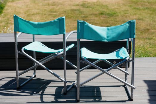 Two turquoise chairs in the garden