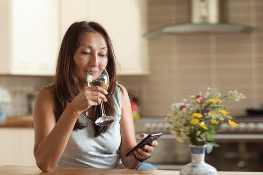 Asian woman texting to friends on the phone