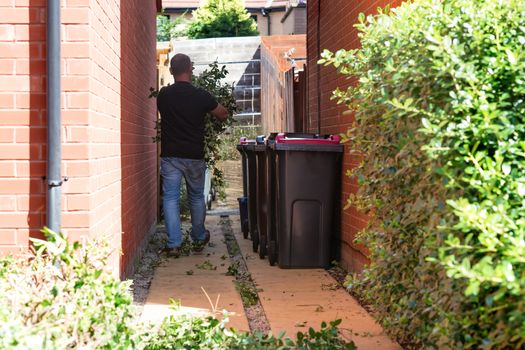 man cleaning and putting litter to the bins