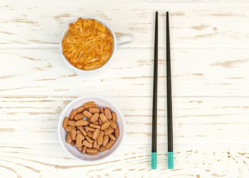 white plate and cup with food additives and chopsticks