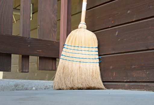 Old broom at a door, selective focus