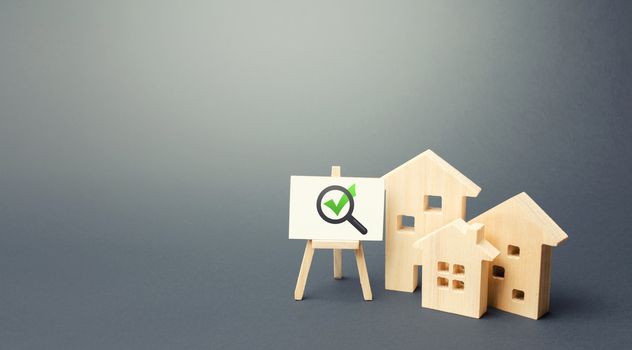 Residential buildings and easel with magnifying glass and green check mark. Compliance of housing with the necessary criteria and quality standards. Search for real estate to buy. Realtor services.