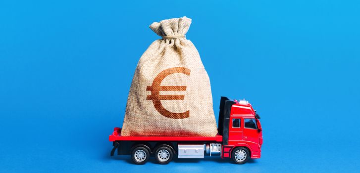 The truck is carrying a huge euro money bag. Great investment. Anti-crisis measures of government. Attracting large funds to the economy for subsidies, support and cheap soft loans for businesses.