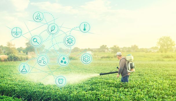 Futuristic innovative technology pictogram and a farmer with a mist blower sprayer walks through the potato plantation. Treatment of the farm field against insect pests, fungal infections