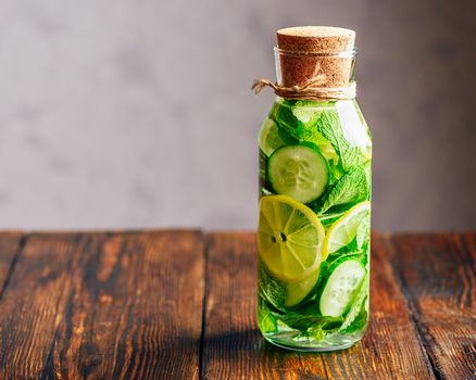 Infusion  with Sliced Lemon, Cucumber and Sprigs of Mint. Copy Space on the Left Side.