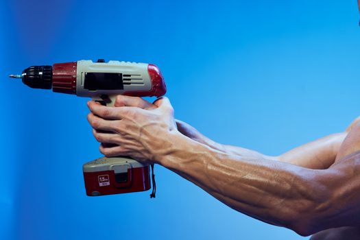 Male hand with tool for repairing a room on isolated background