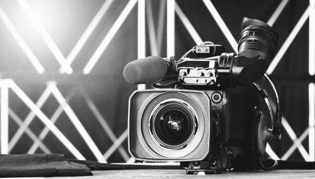 Blurry images of broadcast camera on the crane tripod for easy to shooting or recording and broadcasting content in studio production to on air tv or online internet live show.