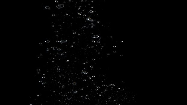 Extream close-up images of water bubbles or soda or liquid texture that splashing and floating up to surface like a explosion in black color background for refreshing carbonate drink concept.