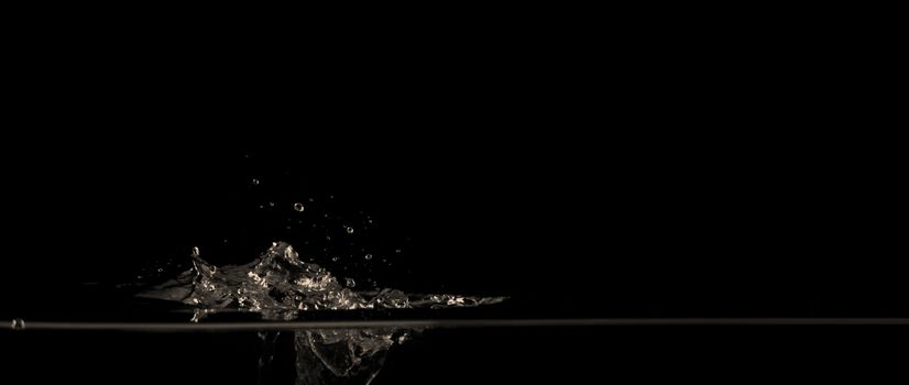 Extream close-up images of water bubbles or soda or liquid texture that splashing and floating up to surface like a explosion in black color background for refreshing carbonate drink concept.