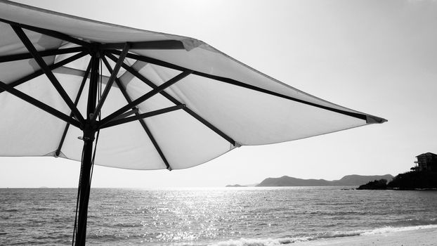 White fabric color texture beach umbrella and brown wood tripod with white cloud and clear blue sky summer sunlight day in low angle view camera for travel asia Thailand Pattaya.