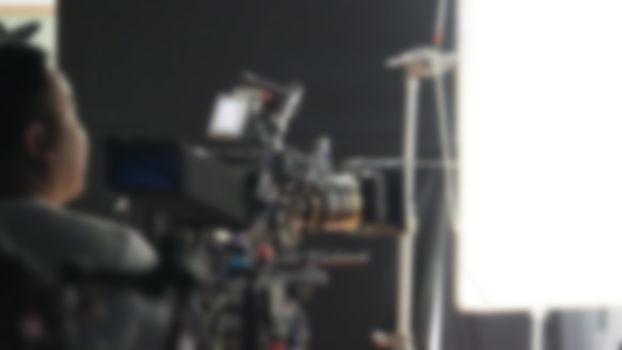 Blurry images of studio video shooting behind the scene or b-roll for online commercial and tvc which done by professional movie director film crew team and camera equipment with lighting set