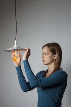 woman with a light bulb on white