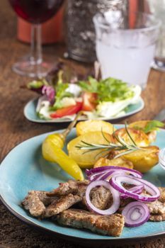 greek gyros with salad and ouzo