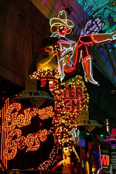 Las Vegas,NV/USA - Sep 12,2018 : Cowgirl neon sign in downtown Las Vegas. The iconic sign of Glitter Gulch is placed in 20 East Fremont Street, in Downtown Las Vegas