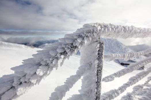 Snow and ice covered stairs fence illustrating extreme cold in the winter