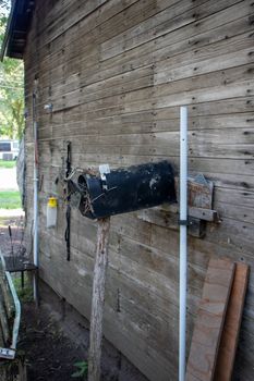 Old Abandoned country mail box with bird nest inside it on the side of a shed. High quality photo