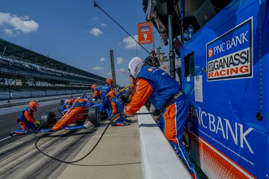 SCOTT DIXON (9) of Auckland, New Zealand brings his car in for service during the Indianapolis 500 at Indianapolis Motor Speedway in Indianapolis Indiana.