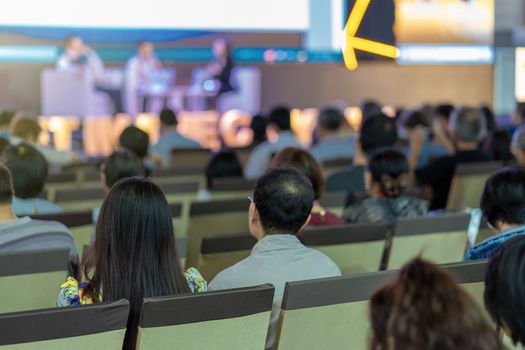 Rear view of Audience listening Speakers on the stage in the conference hall or seminar meeting, business and education about investment concept