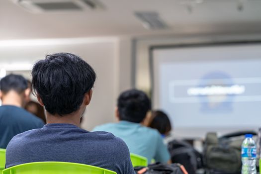 Rear view of Audience listening the Speaker on the stage in the conference hall or seminar meeting, business and education concept