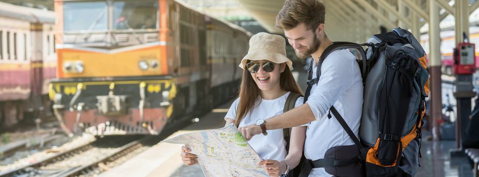 Banner and web page or cover template of Multiethnic Travelers are looking at the map at the train station, Travel and transportation concept