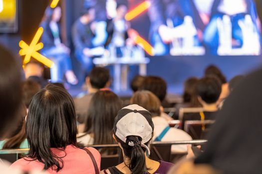 Rear view of Audience listening Speakers on the stage in the conference hall or seminar meeting, business and education about investment concept