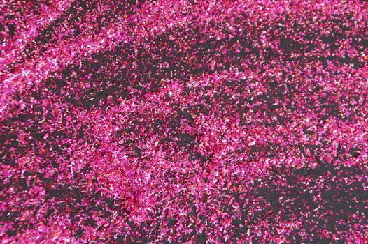 dark pink shiny glitter on black background.