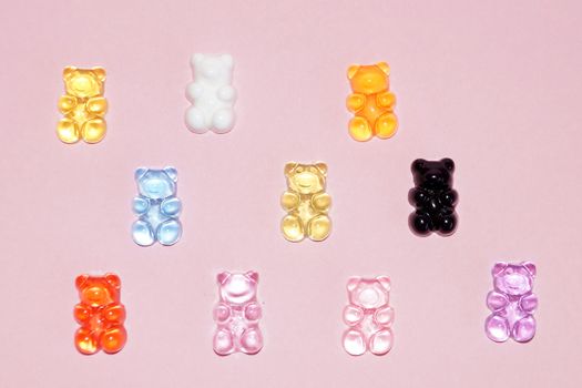 multi-colored plastic bears symbolizing friendship of peoples on a pink background